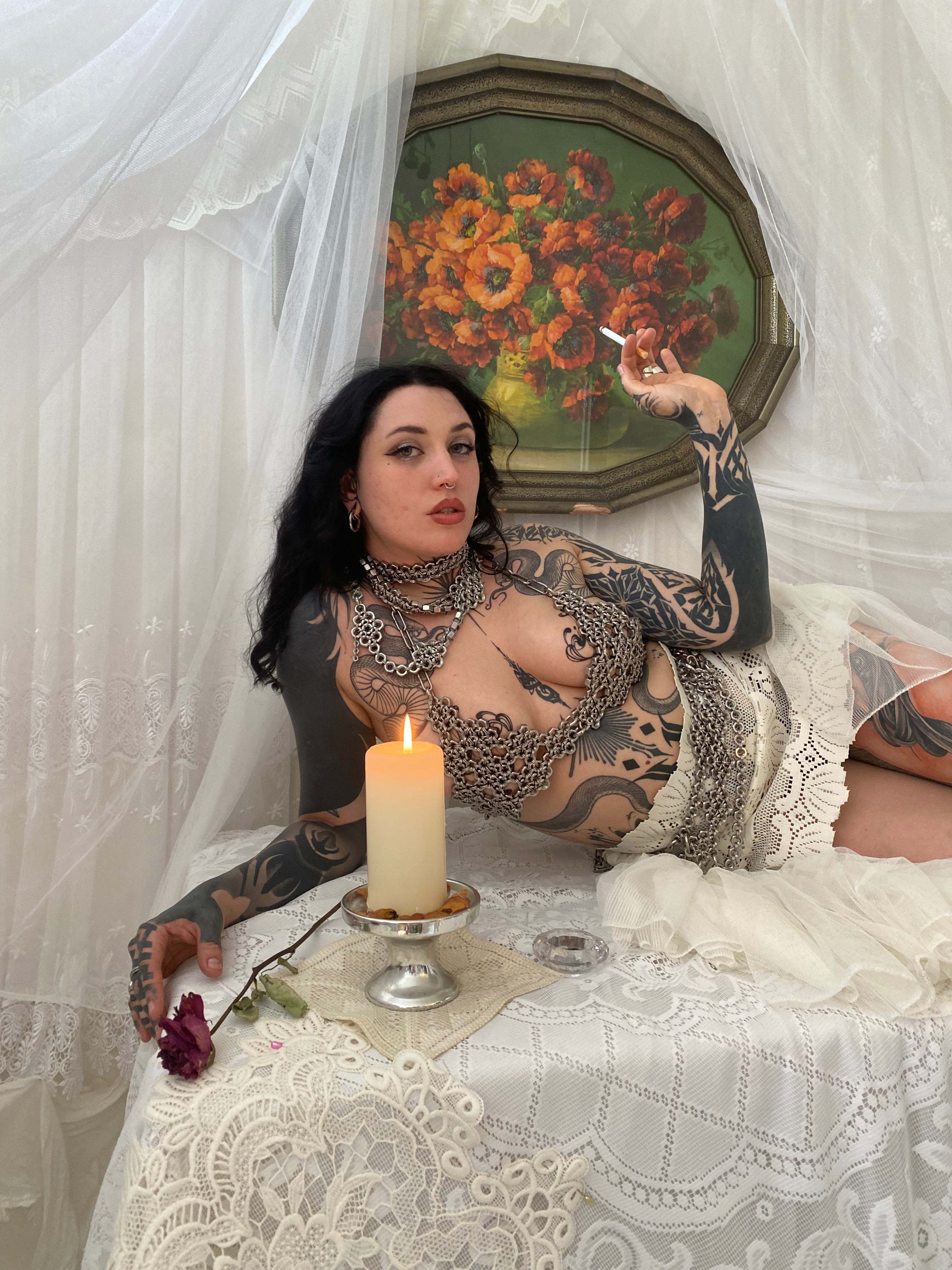 Model showcasing a vintage gothic outfit paired with a floral-patterned industrial, bold, alternative-fashion chainmail bra.