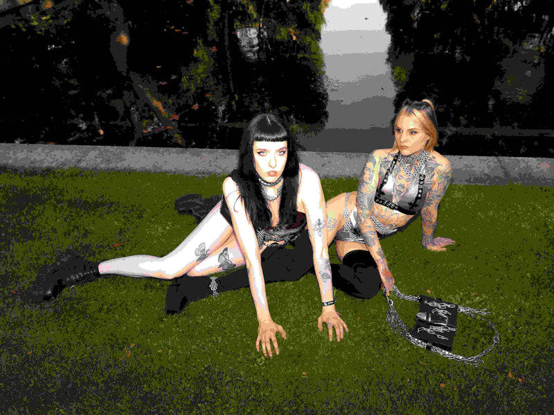 alternative fashion inspo with chainmail jewellery and leather handbags and latex sets presented by two alternative models
