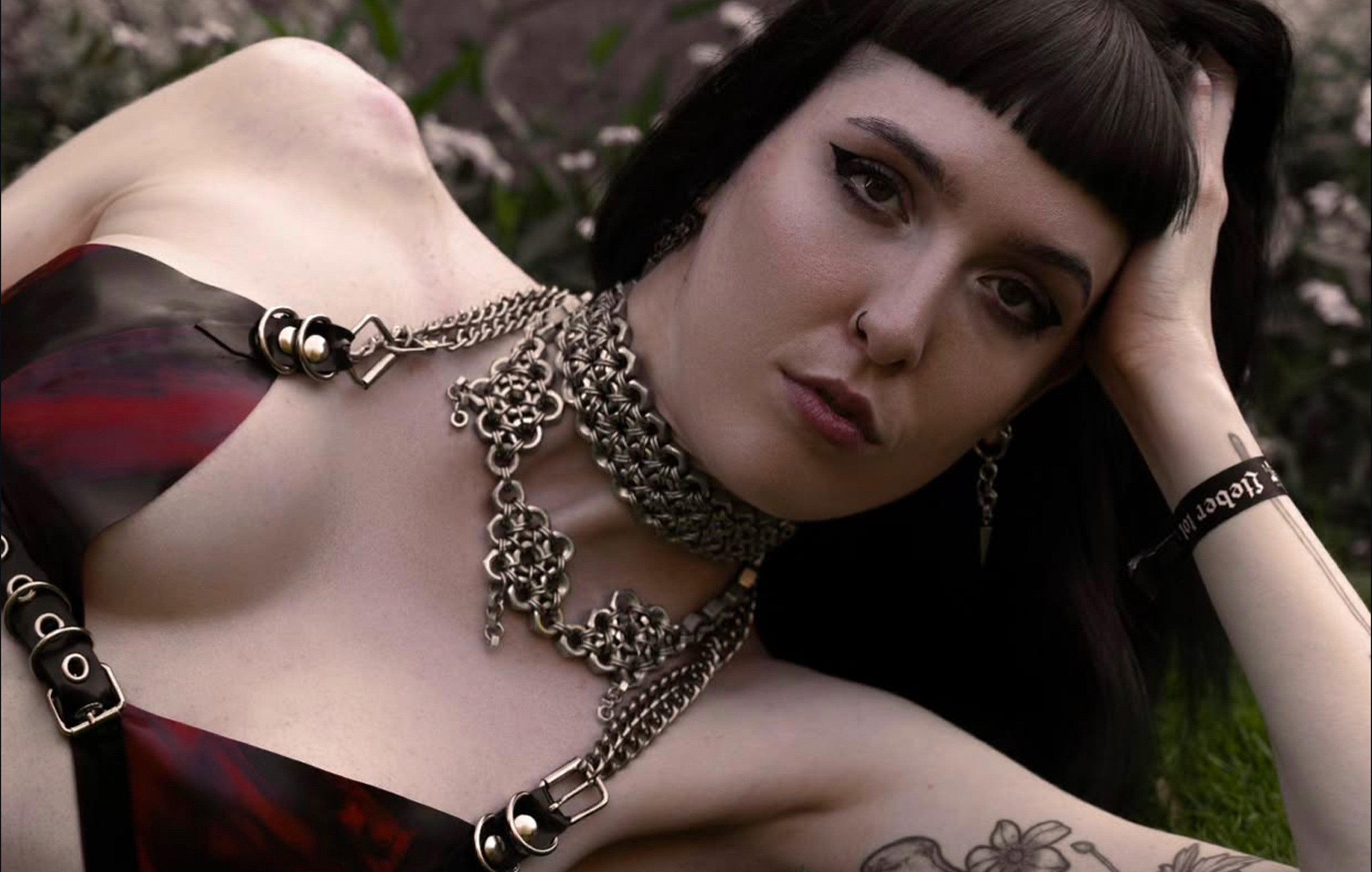 Alternative model wearing unique chainmail-patterned chokers and necklaces made from genuine screens, showcasing an industrial bold fashion look.