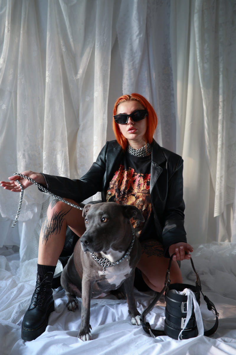 Techno model is wearing chainmail choker made from screws and chainmails in the name of industrial fashion. Also holds a bold unique cylinder shapped repurosed leather handbag.