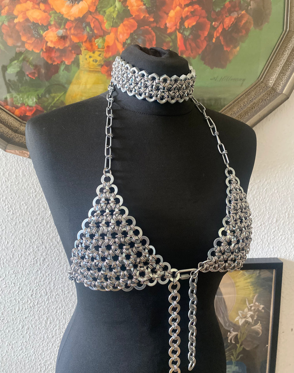 Chainmail-inspired choker made from real stainless steel industrial screws, displayed on a puppet; doll also wearing an industrial chain bra crafted from genuine screw details, creating a heavy, statement look.