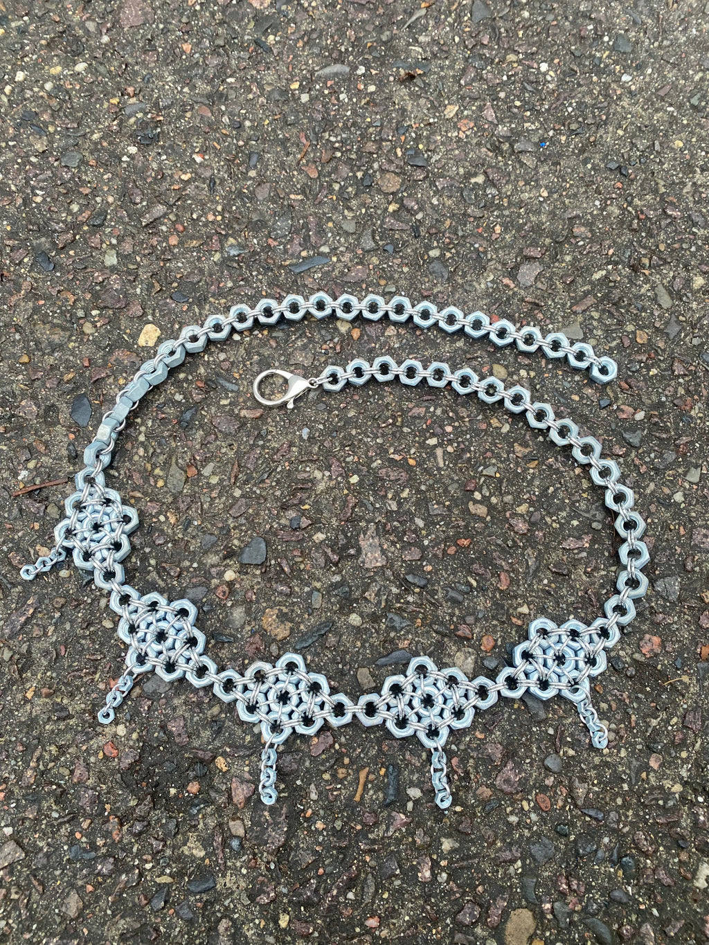 Unique handmade chainmail belt made from stainless steel rings and genuine screws, displayed in the photo. Crafted in Berlin, inspired by techno and alternative fashion.