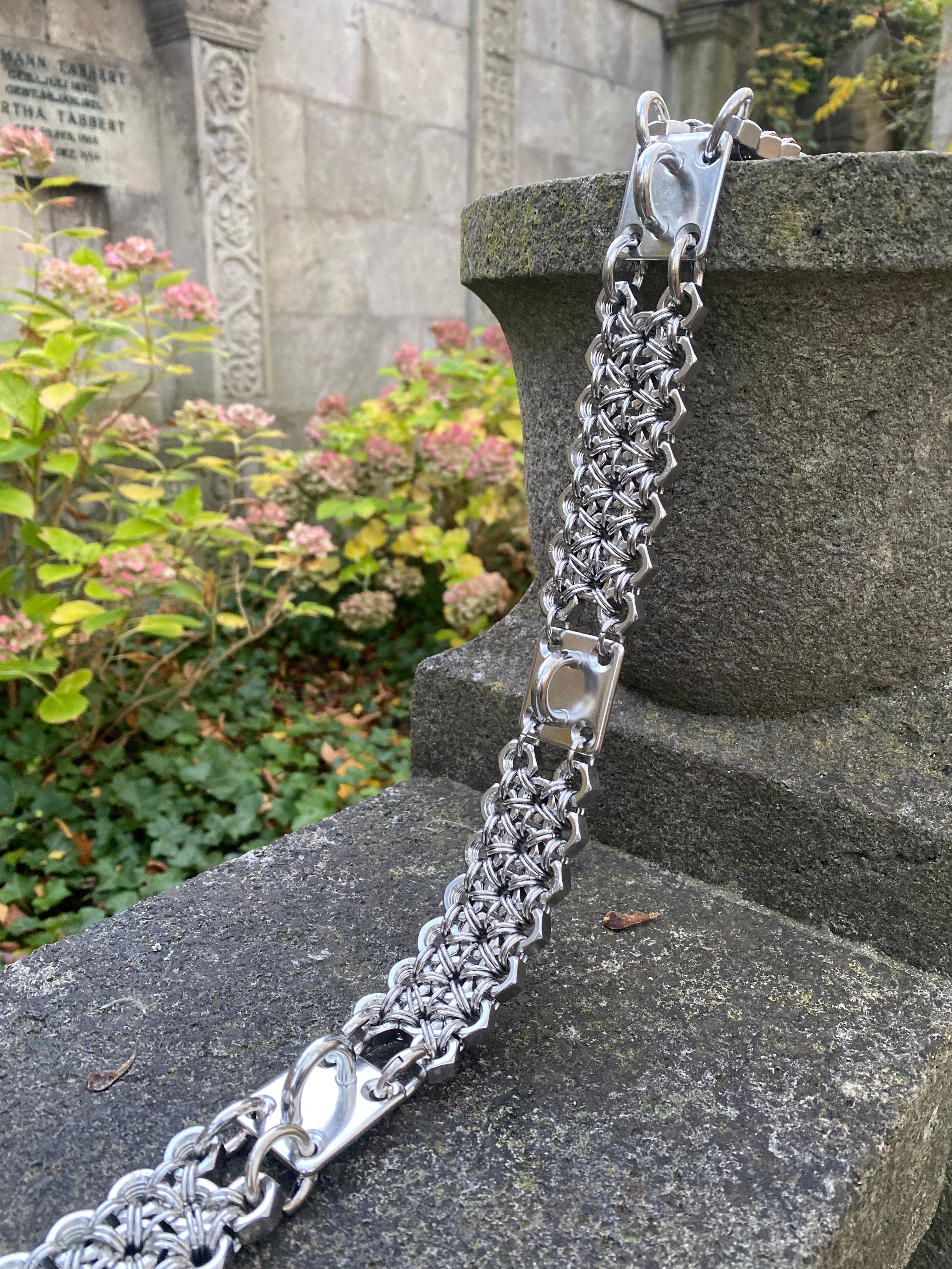 stainless steel chainmail belt presented on rocks from industrial screws made by hand in Berlin