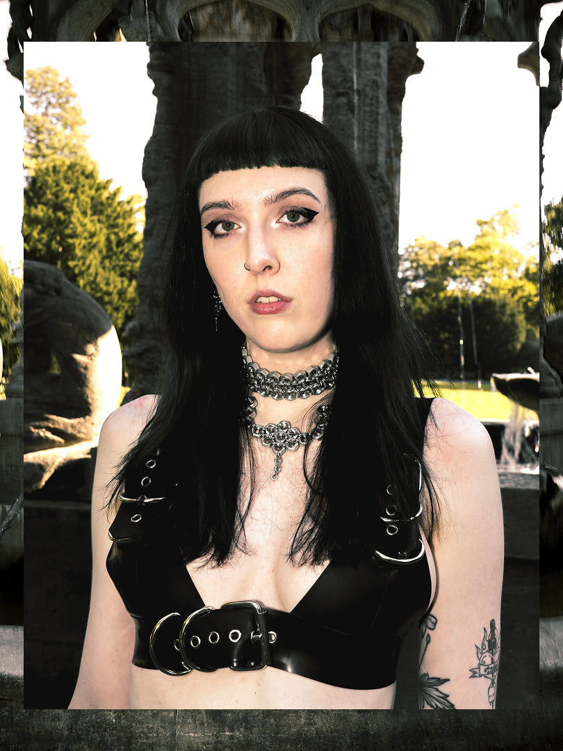Alt model is wearing an industrial fashion choker made from stainless steel screws and rings and latex top with metal details